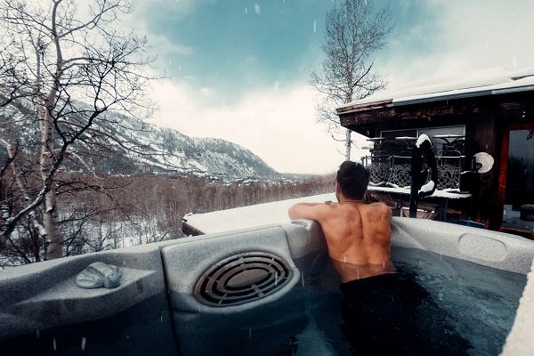 man resting in a hot tub
